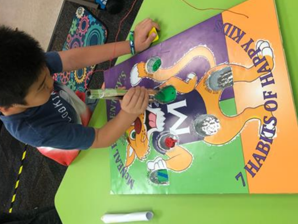 student drawing on poster